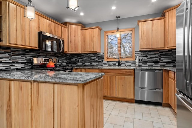 kitchen featuring appliances with stainless steel finishes, tasteful backsplash, a sink, dark stone countertops, and light brown cabinets
