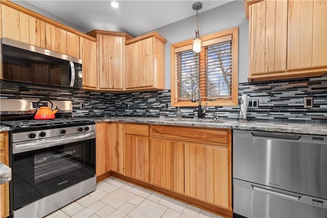 kitchen featuring backsplash, appliances with stainless steel finishes, a sink, and light brown cabinets