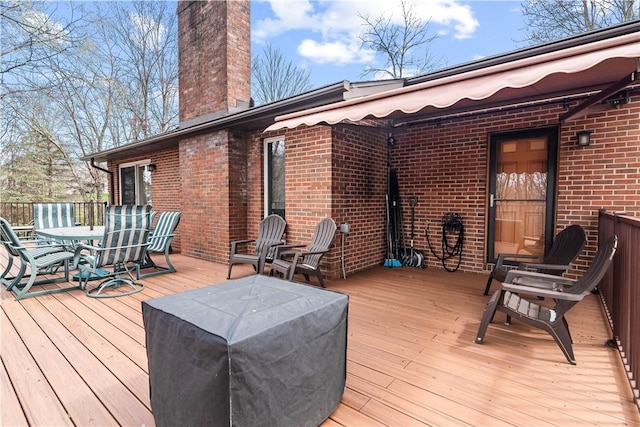 wooden terrace with outdoor dining space
