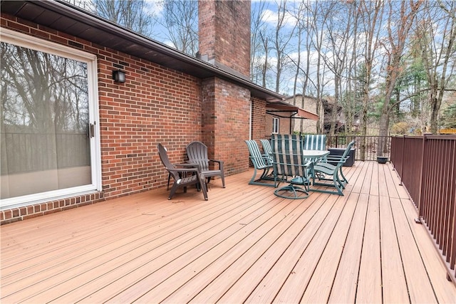 wooden deck featuring outdoor dining space
