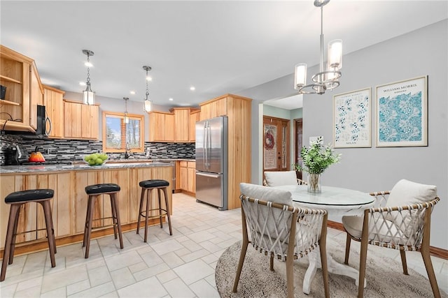 dining space with an inviting chandelier and recessed lighting