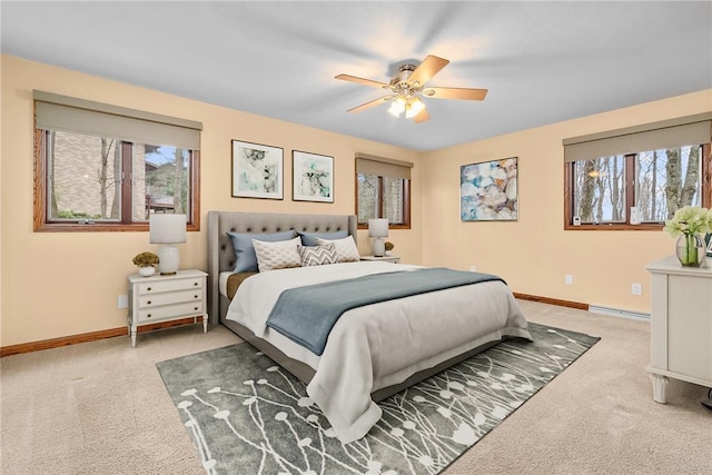 carpeted bedroom featuring baseboards, a ceiling fan, and multiple windows