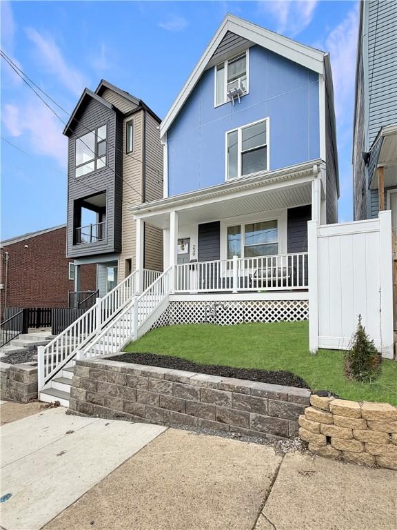 view of front of house with a front lawn and covered porch
