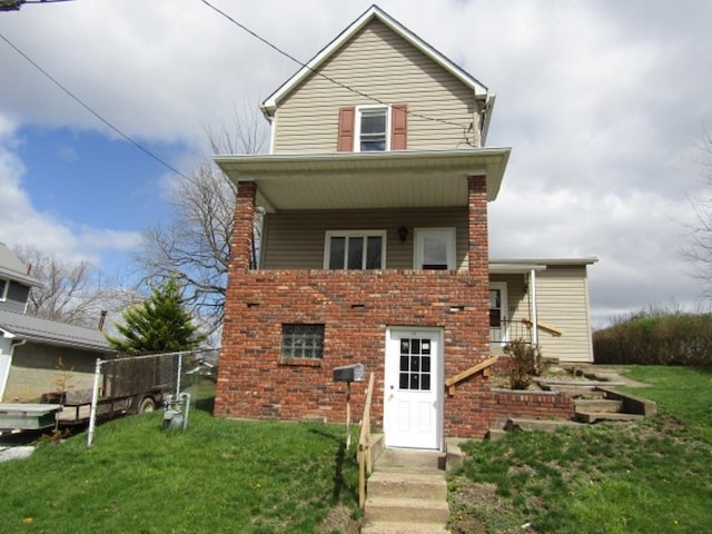traditional-style house with a front yard and fence