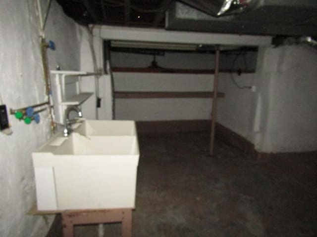 unfinished basement featuring a sink
