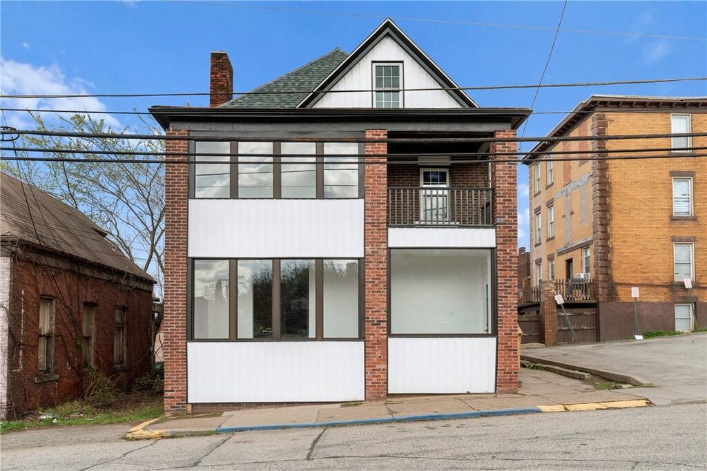 7561 Roslyn St, Swissvale, PA 15218 - view of front of home featuring a chimney and a balcony