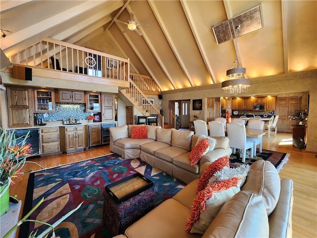 288 Latonka Dr, Jackson Twp Mer, PA 16137 - living room featuring beverage cooler, high vaulted ceiling, light wood-style floors, stairway, and beam ceiling