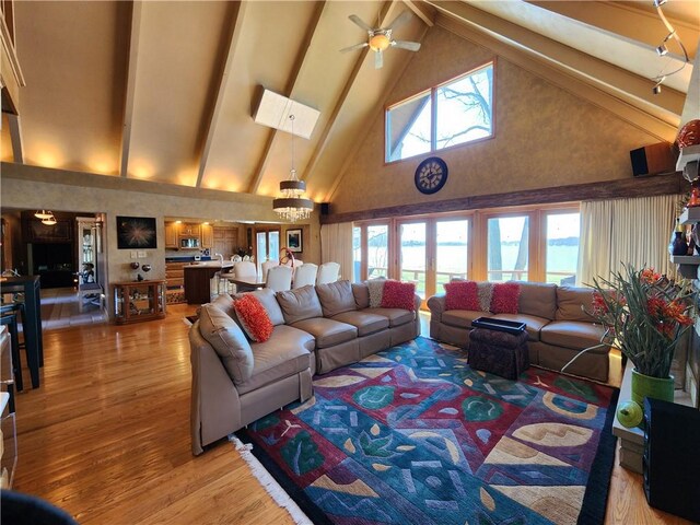 288 Latonka Dr, Jackson Twp Mer, PA 16137 - living room with high vaulted ceiling, light wood finished floors, beamed ceiling, a skylight, and a ceiling fan