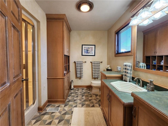 288 Latonka Dr, Jackson Twp Mer, PA 16137 - bathroom featuring baseboards, tile patterned floors, toilet, vanity, and a shower with shower door