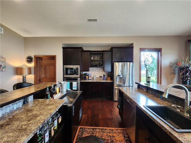 288 Latonka Dr, Jackson Twp Mer, PA 16137 - kitchen featuring stainless steel appliances, a sink, dark wood-type flooring, light countertops, and backsplash
