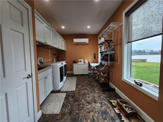 288 Latonka Dr, Jackson Twp Mer, PA 16137 - laundry room with cabinet space, stone finish floors, a wall unit AC, baseboards, and recessed lighting