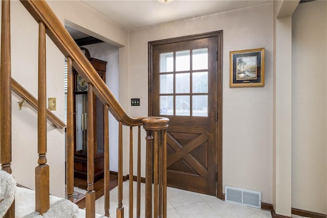 foyer with visible vents, baseboards, and stairs