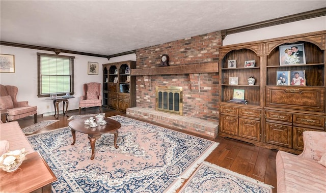 living room featuring baseboards, ornamental molding, a textured ceiling, a brick fireplace, and dark wood finished floors