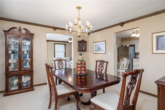 dining area with light carpet, an inviting chandelier, crown molding, and baseboards