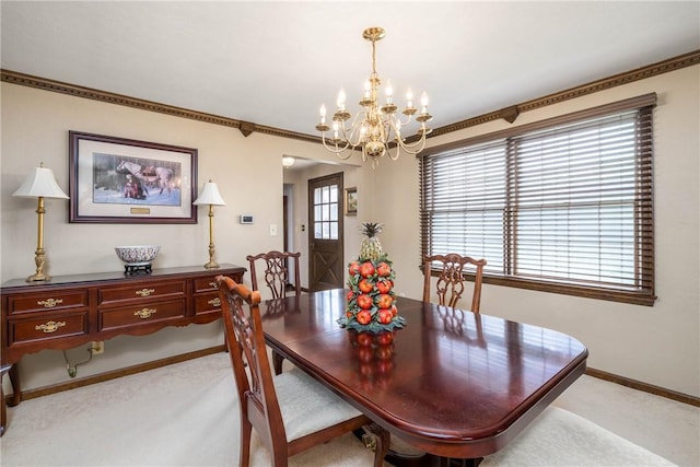 dining room featuring light colored carpet, an inviting chandelier, and plenty of natural light