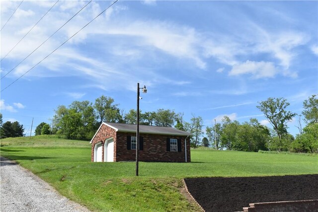 511 Pleasant Valley Rd, Buffalo Twp Wsh, PA 15301 - view of home's exterior with a lawn, a garage, an outbuilding, and brick siding