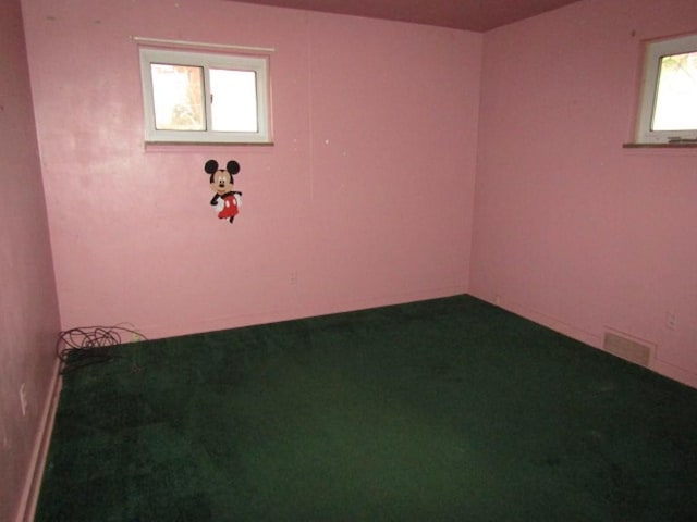 unfurnished room with visible vents and carpet flooring