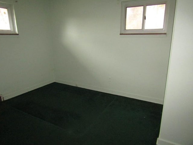 unfurnished room with baseboards