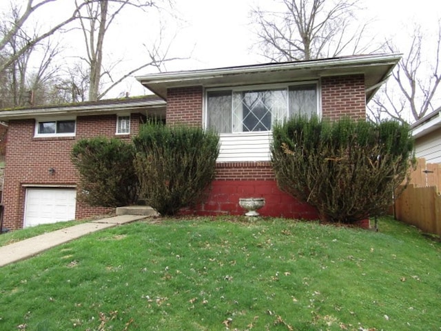 view of front of home with fence, brick siding, an attached garage, and a front lawn