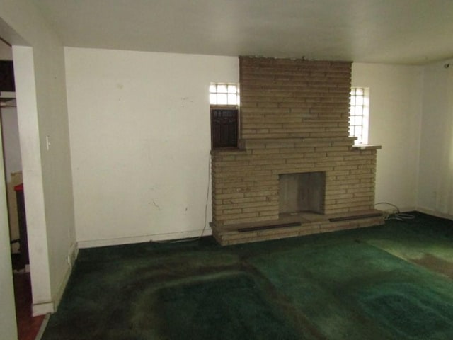 living area with a brick fireplace and carpet floors