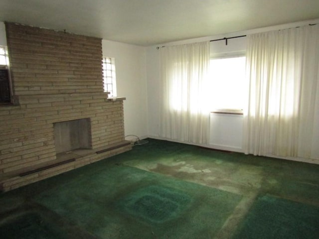 unfurnished living room featuring carpet floors and a fireplace
