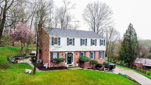 112 Carol Dr, Peters Twp, PA 15317 - colonial home with a chimney, a front lawn, and brick siding