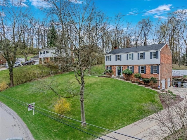 112 Carol Dr, Peters Twp, PA 15317 - colonial inspired home featuring brick siding, concrete driveway, a chimney, a front lawn, and a garage