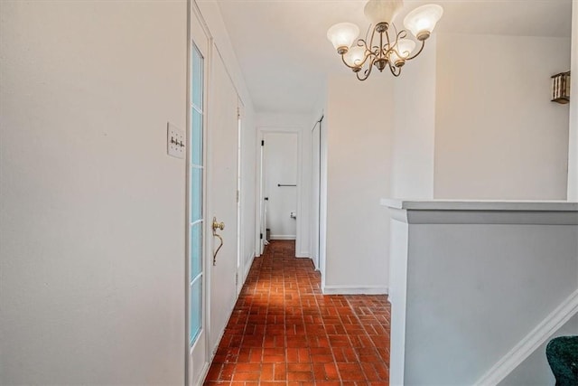 112 Carol Dr, Peters Twp, PA 15317 - hallway featuring brick patterned flooring and a chandelier