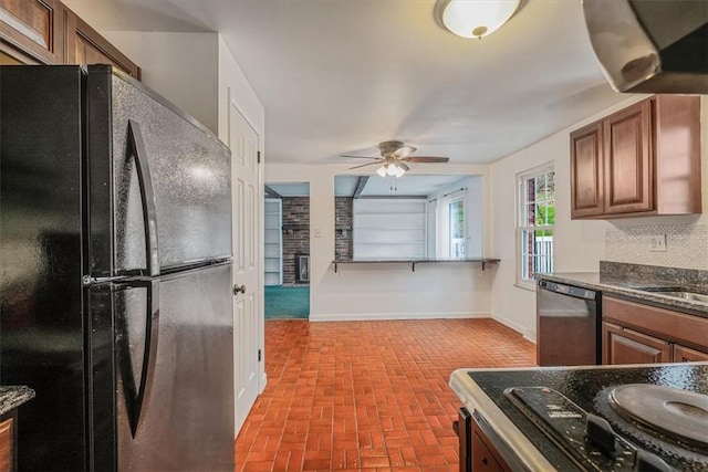 112 Carol Dr, Peters Twp, PA 15317 - kitchen with freestanding refrigerator, stainless steel dishwasher, a ceiling fan, brick patterned floors, and stovetop