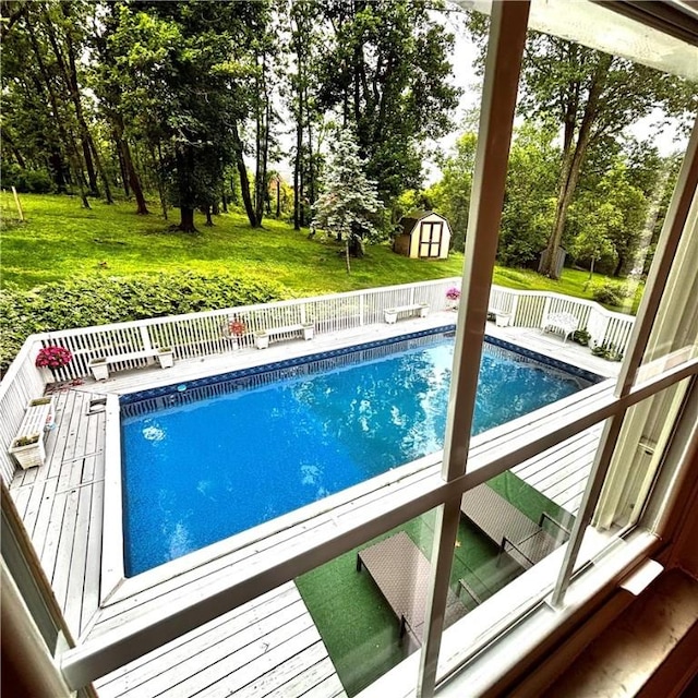 112 Carol Dr, Peters Twp, PA 15317 - swimming pool featuring a storage shed, a wooden deck, and view of scattered trees