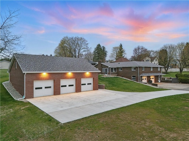 exterior space featuring brick siding, driveway, and a lawn