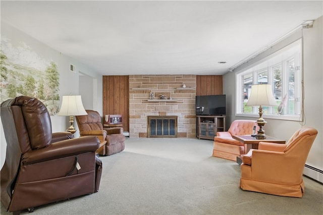 living room with visible vents, a stone fireplace, carpet flooring, and wood walls