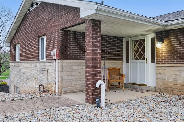 property entrance with brick siding