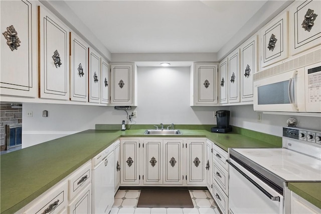 kitchen with a sink, white cabinetry, and white appliances