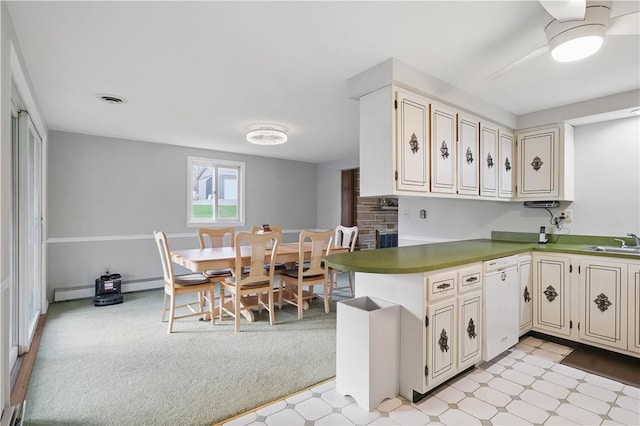 kitchen with ceiling fan, light floors, visible vents, dishwasher, and a sink