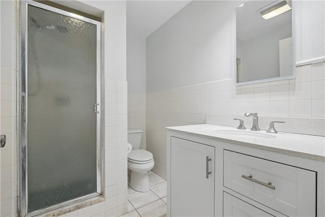 full bath featuring toilet, tile walls, vanity, tile patterned flooring, and a stall shower