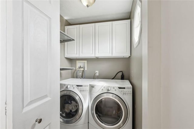 laundry area featuring independent washer and dryer and cabinet space