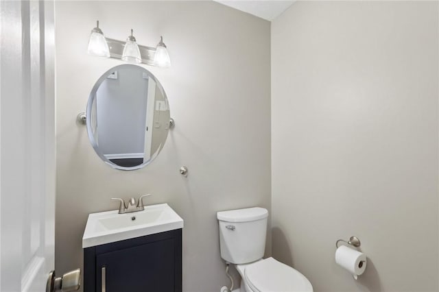 bathroom featuring toilet and vanity