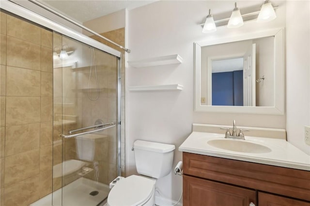 full bath with toilet, a shower stall, and vanity
