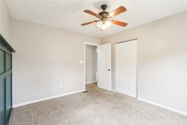 unfurnished bedroom featuring a closet, baseboards, carpet flooring, and ceiling fan