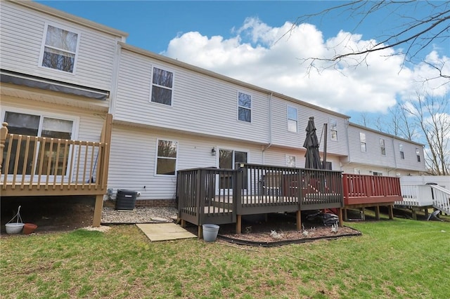 rear view of property with a yard, central AC, and a wooden deck