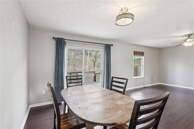 dining area featuring dark wood-style floors, baseboards, and ceiling fan