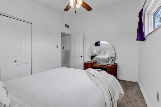 carpeted bedroom with baseboards, visible vents, a closet, and vaulted ceiling