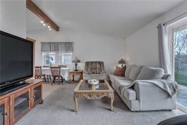 living room featuring lofted ceiling with beams, plenty of natural light, and carpet floors