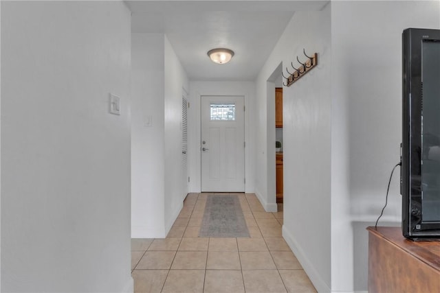 entryway featuring light tile patterned flooring and baseboards