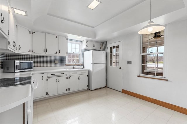 40 Terrace Rd, East Bethlehem, PA 15348 - kitchen with a sink, light countertops, freestanding refrigerator, a tray ceiling, and stainless steel microwave