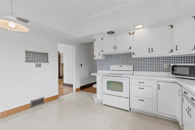 40 Terrace Rd, East Bethlehem, PA 15348 - kitchen featuring stainless steel microwave, light countertops, backsplash, visible vents, and white range with electric cooktop