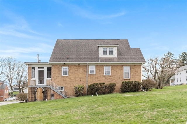 40 Terrace Rd, East Bethlehem, PA 15348 - rear view of property featuring roof with shingles, a yard, brick siding, and a sunroom