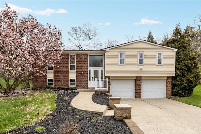 137 Loire Valley Dr, Shaler, PA 15209 - bi-level home featuring brick siding, french doors, an attached garage, and concrete driveway