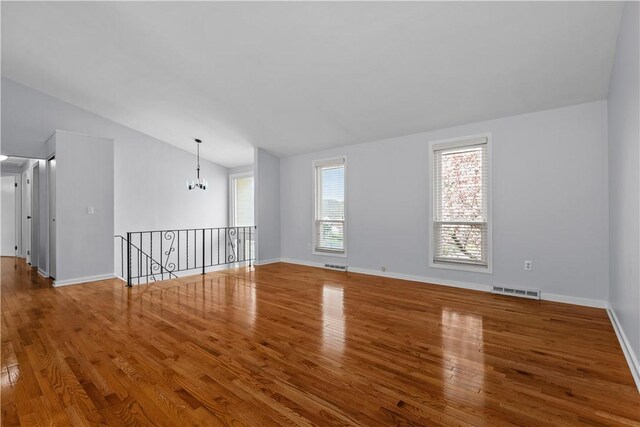 137 Loire Valley Dr, Shaler, PA 15209 - spare room featuring vaulted ceiling, visible vents, wood finished floors, baseboards, and a notable chandelier
